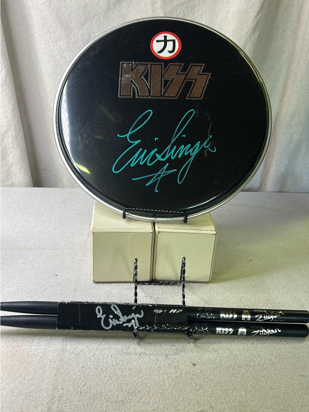 Kiss Black Drumhead with Eric  Singer’s Signature and Signed Black Drumsticks
